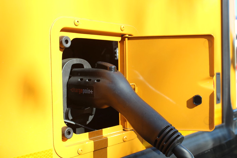 Close-up of an electric school bus charging port.